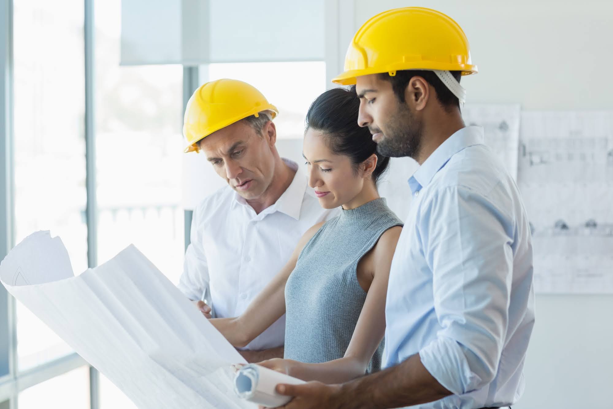 Construction crew reviewing plans on a job site