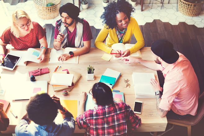 Diverse group collaborating around a work table